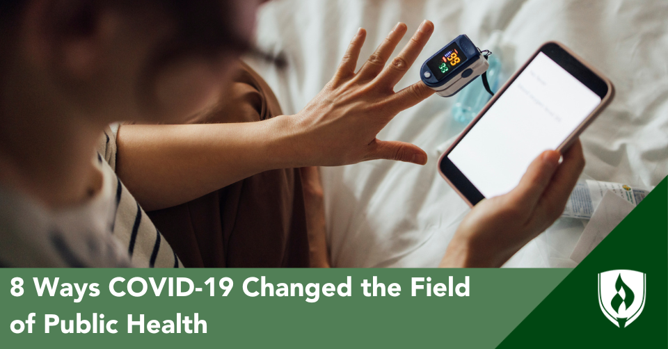 Someone holds a phone loaded with a healthcare app, connected to a pulse oximeter