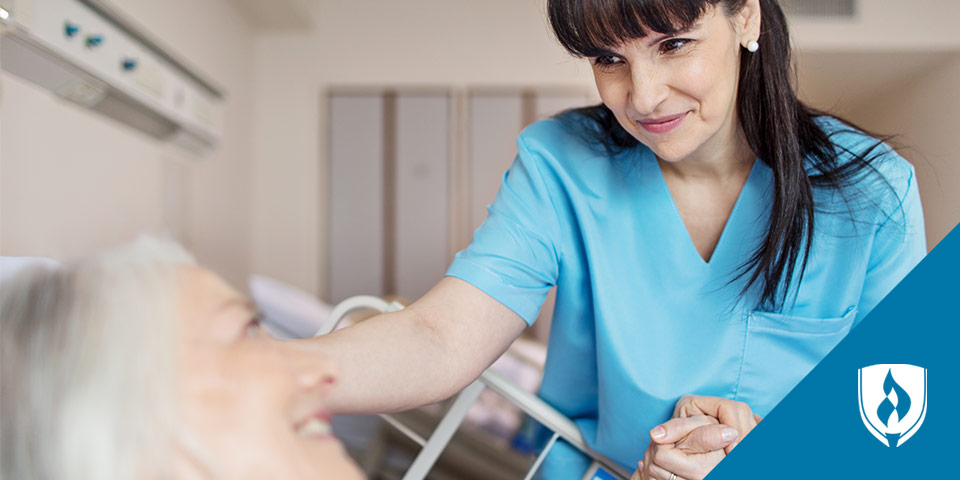 female nurse helping patient in hospital bed