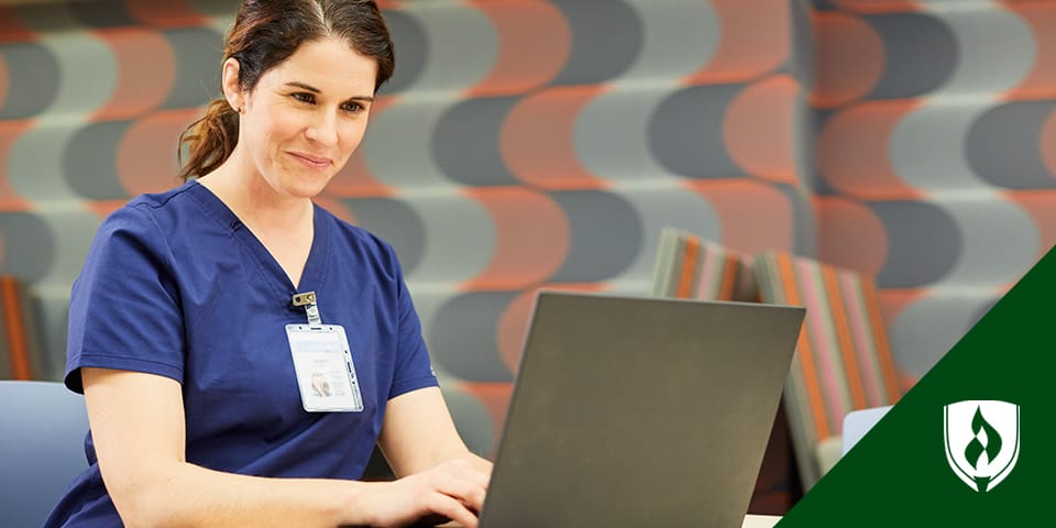 Photo of a student nurse working at a laptop.